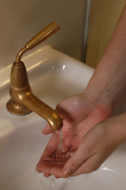 Hand washing with a copper tap at Selly Oak Hospital, Birmingham, UK