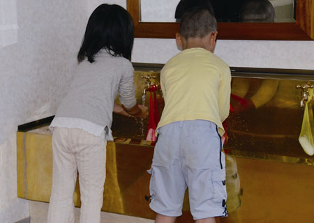 Figure 4: Children at Mejiro Daycare Center in Tokyo, Japan, using brass taps at a brass sink
