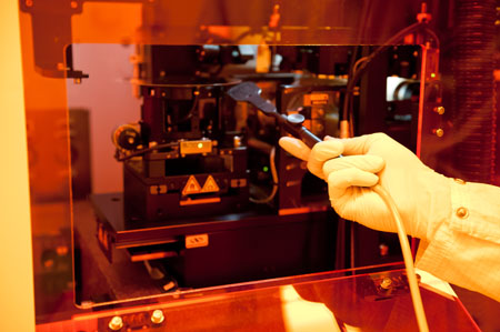 A researcher from the Cockrell School of Engineering, University of Texas, working on glass wafers, etched with nanoscale features <br>Credit: Cockrell School of Engineering, University of Texas at Austin